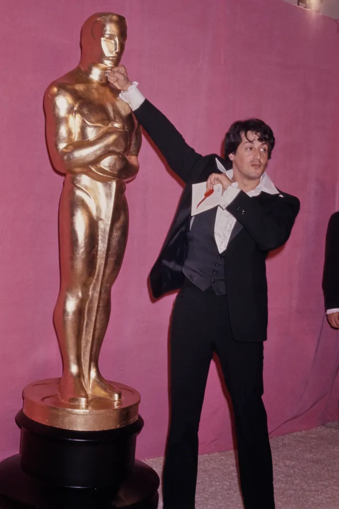 Stallone punching an Oscar statue in the 49th Academy Awards press room, at the Dorothy Chandler Pavilion in Los Angeles, California, 28th March 1977.