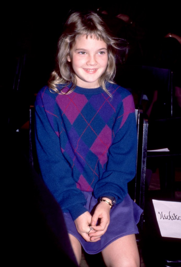 Drew Barrymore, age 6, smiling at an event in 1980.