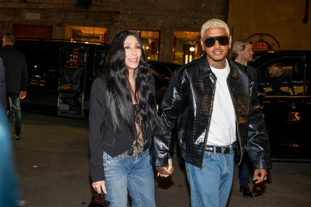 American singer Cher and Alexander Edwards holding hands.