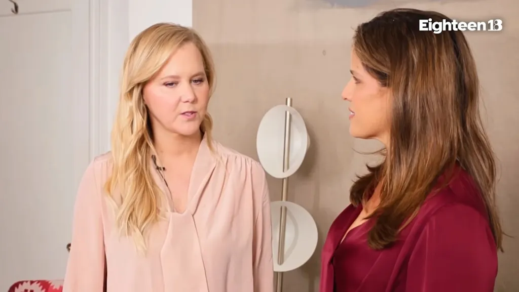 Amy Schumer speaking with another woman.