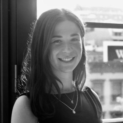 Black and white photo of Annabel Lassally smiling.