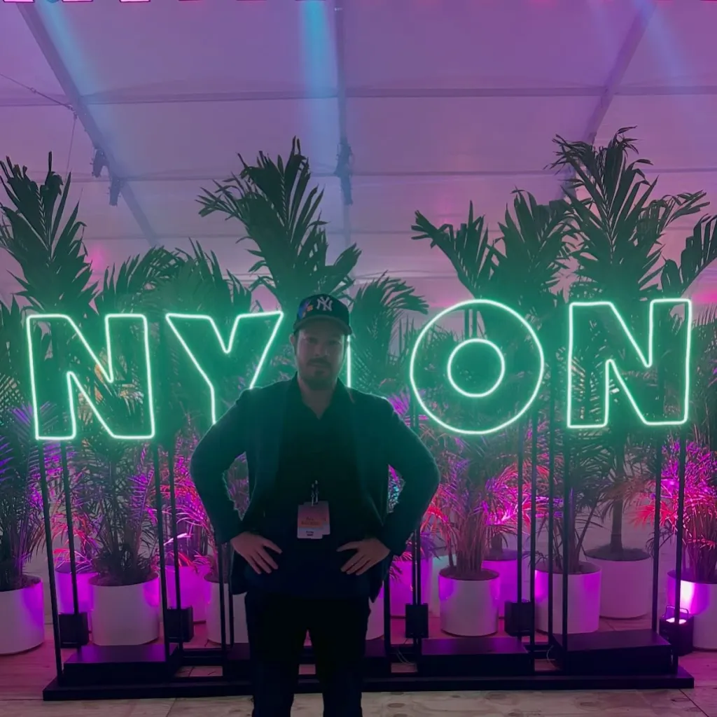 Bryan Goldberg stands in front of a green 