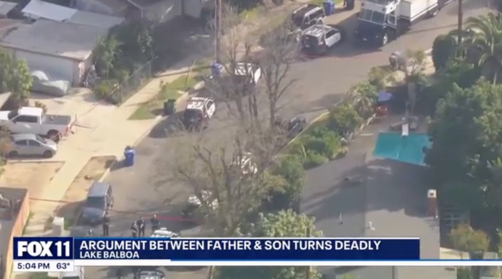 Aerial view of police cars and emergency vehicles on a street in a residential neighborhood.