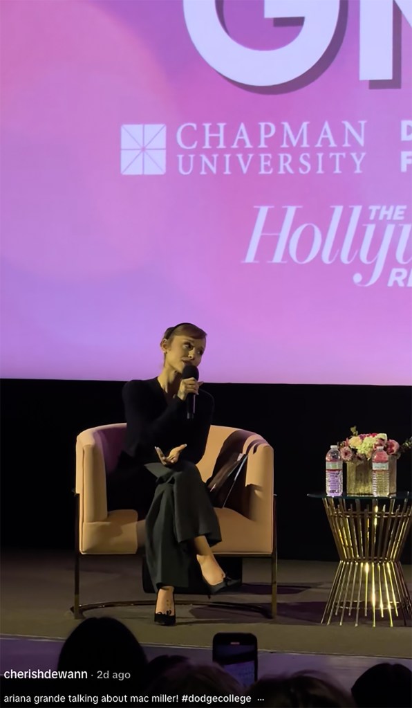 Ariana Grande speaking at Chapman University, with a large