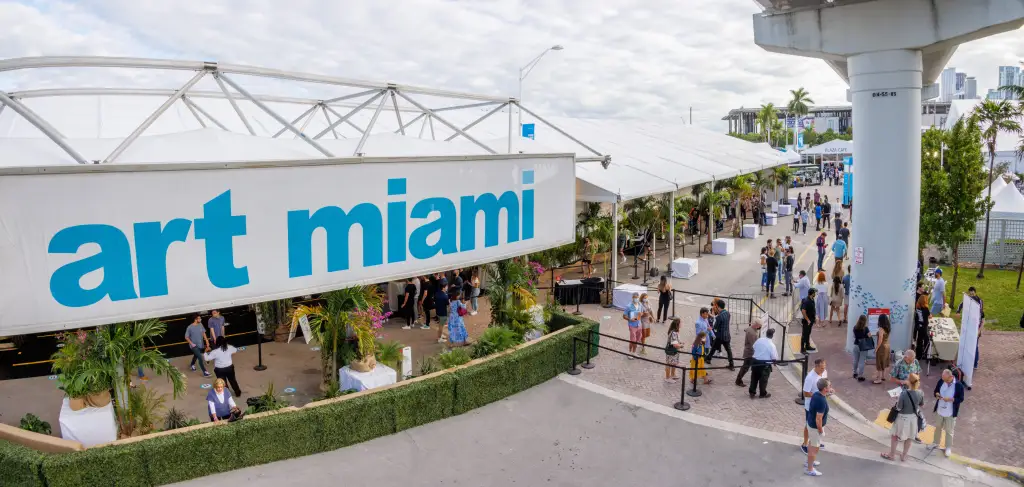 People attending the Art Miami fair, with a large 