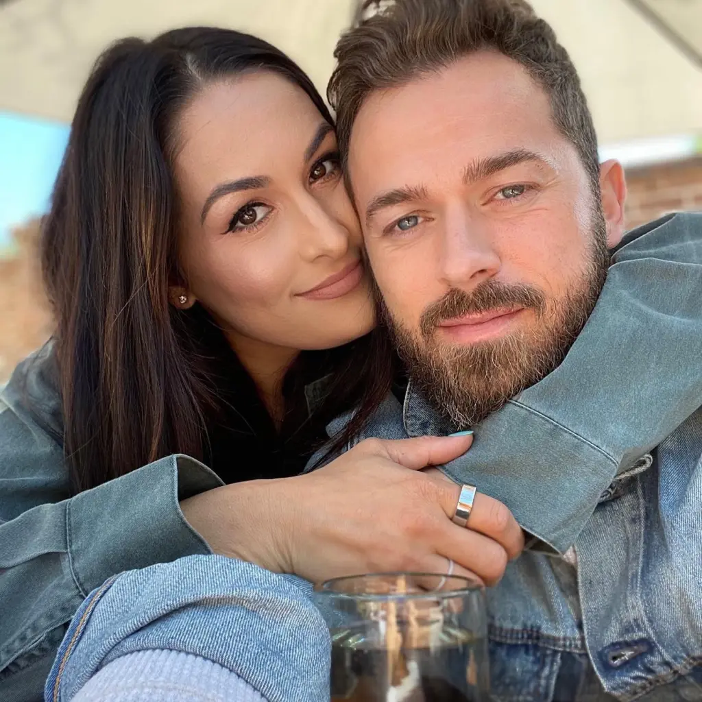 Nikki Bella embraces Artem Chigvintsev.