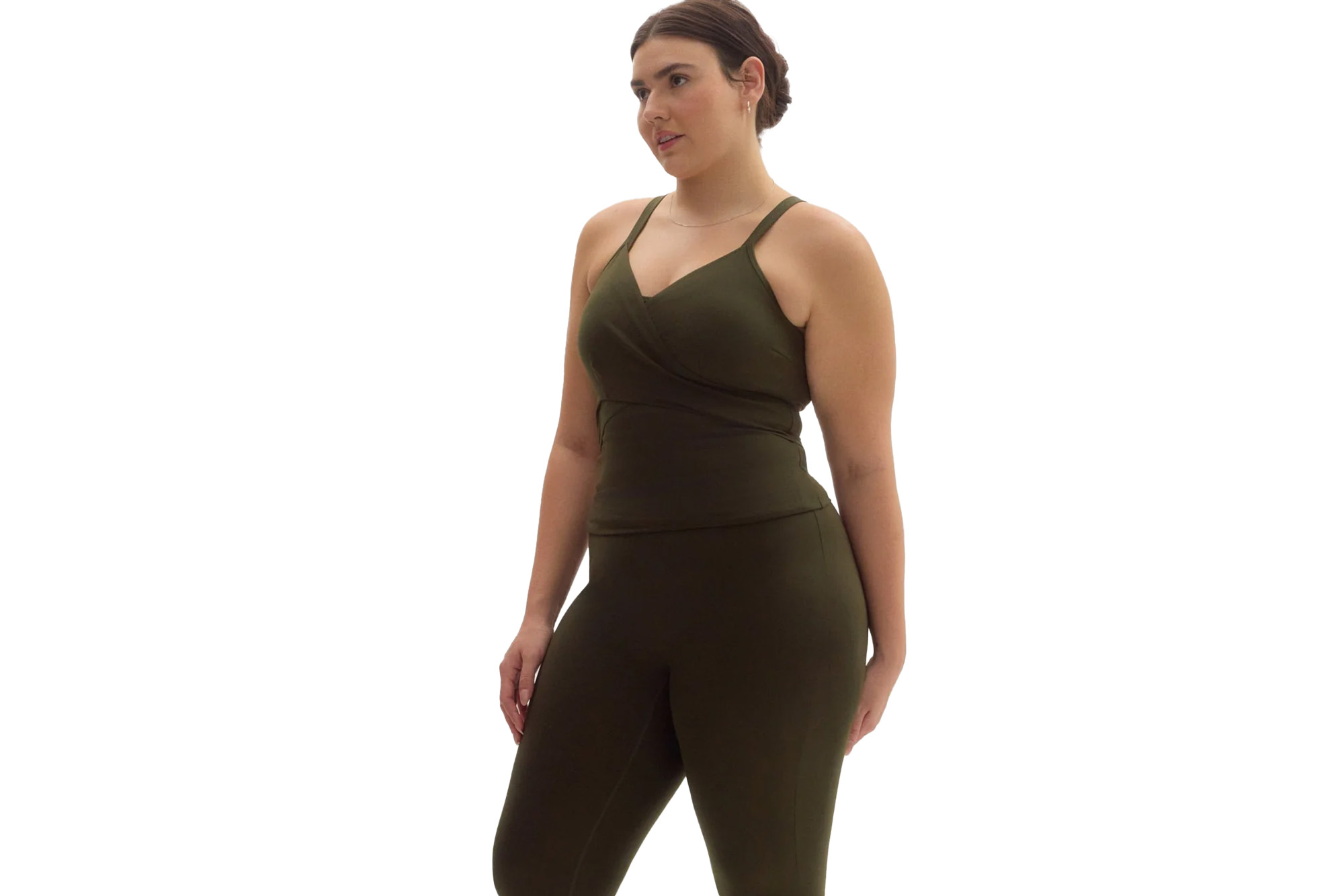Woman in a dark green V-neck tank top and matching leggings.