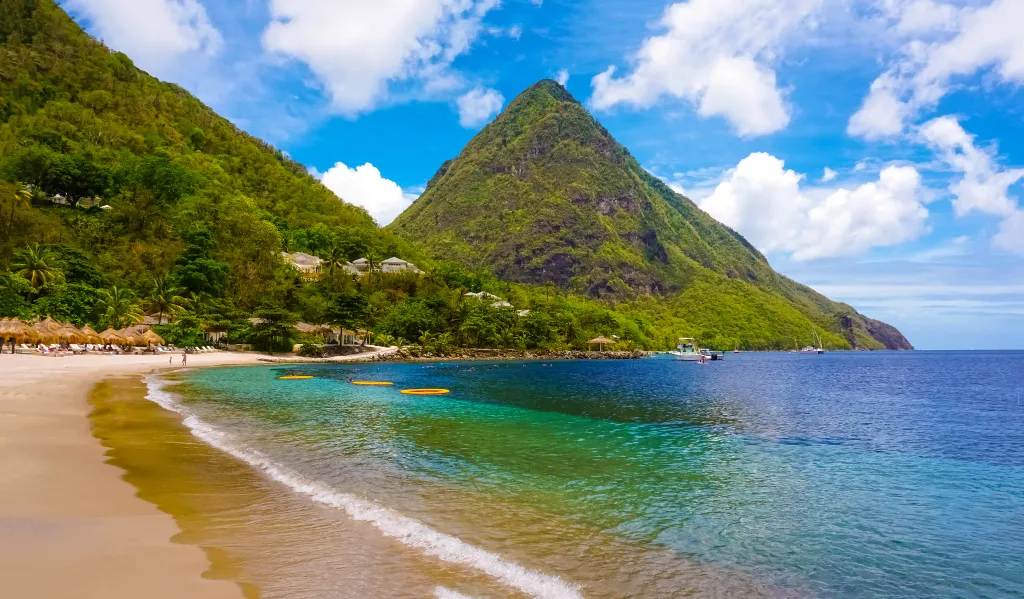 Beautiful white beach in Saint Lucia with a mountain backdrop.