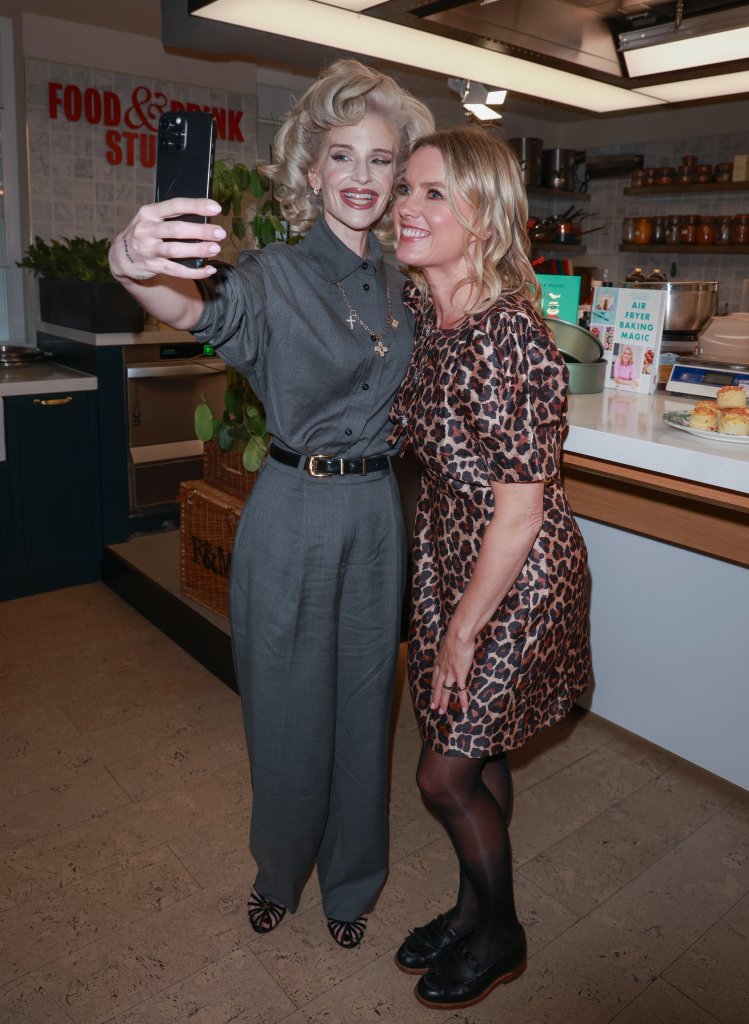 Kelly Osbourne taking a selfie with Juliet Sear at the launch of Juliet Sear's bakeware collection.