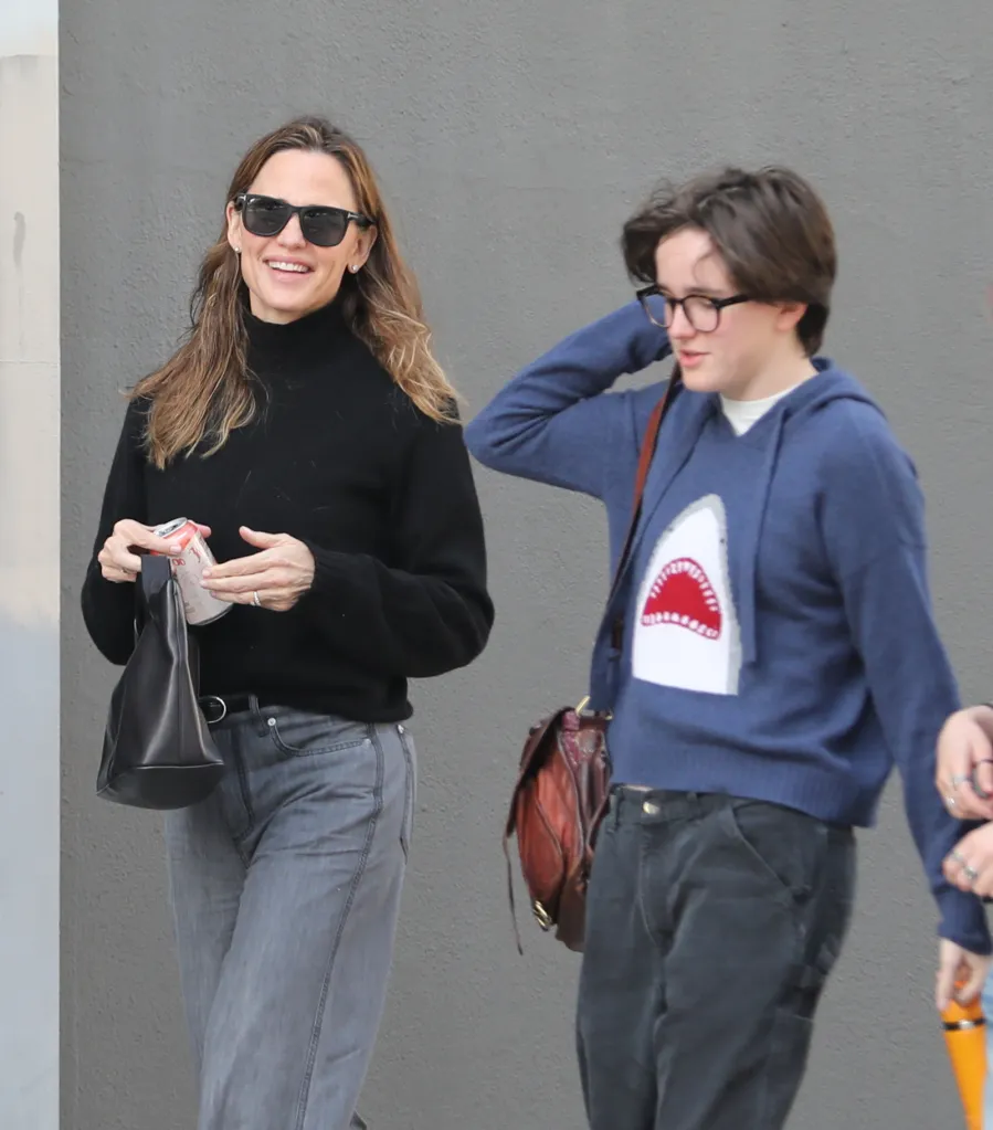Jennifer Garner and Fin Affleck walking together, with Jennifer Garner holding a soda can.