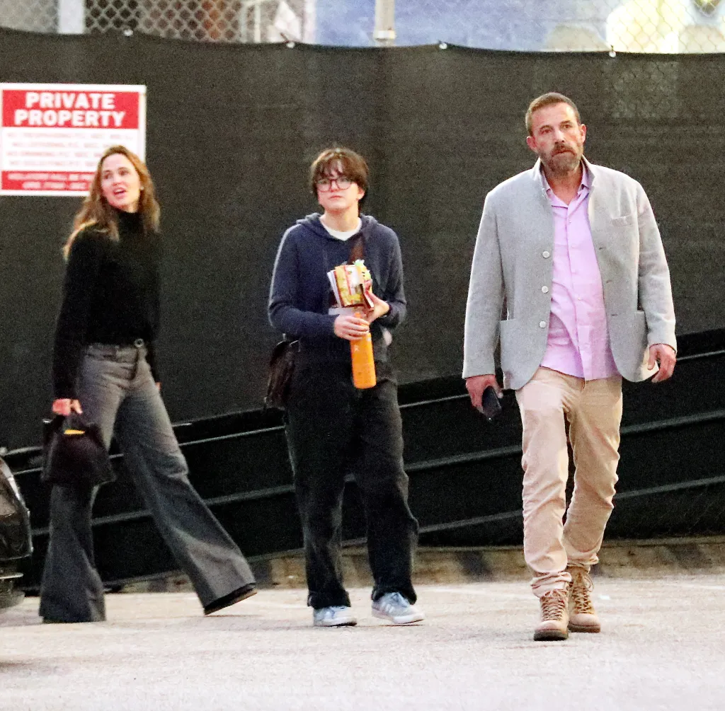 Ben Affleck, Jennifer Garner, and Fin Affleck walk outside the Pantages Theatre.