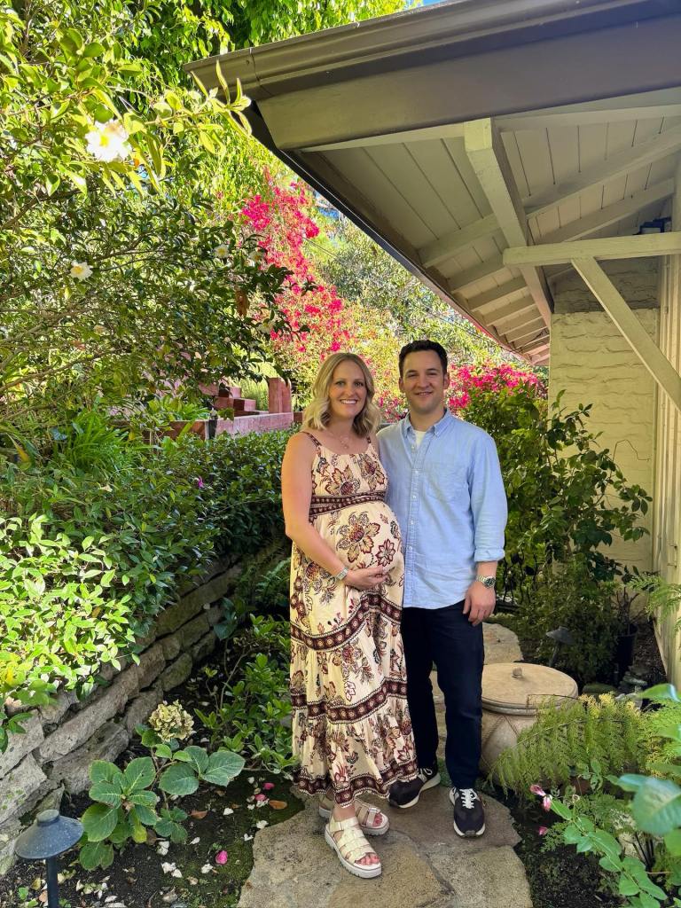 Tessa Angermeier, pregnant, and Ben Savage standing outdoors.