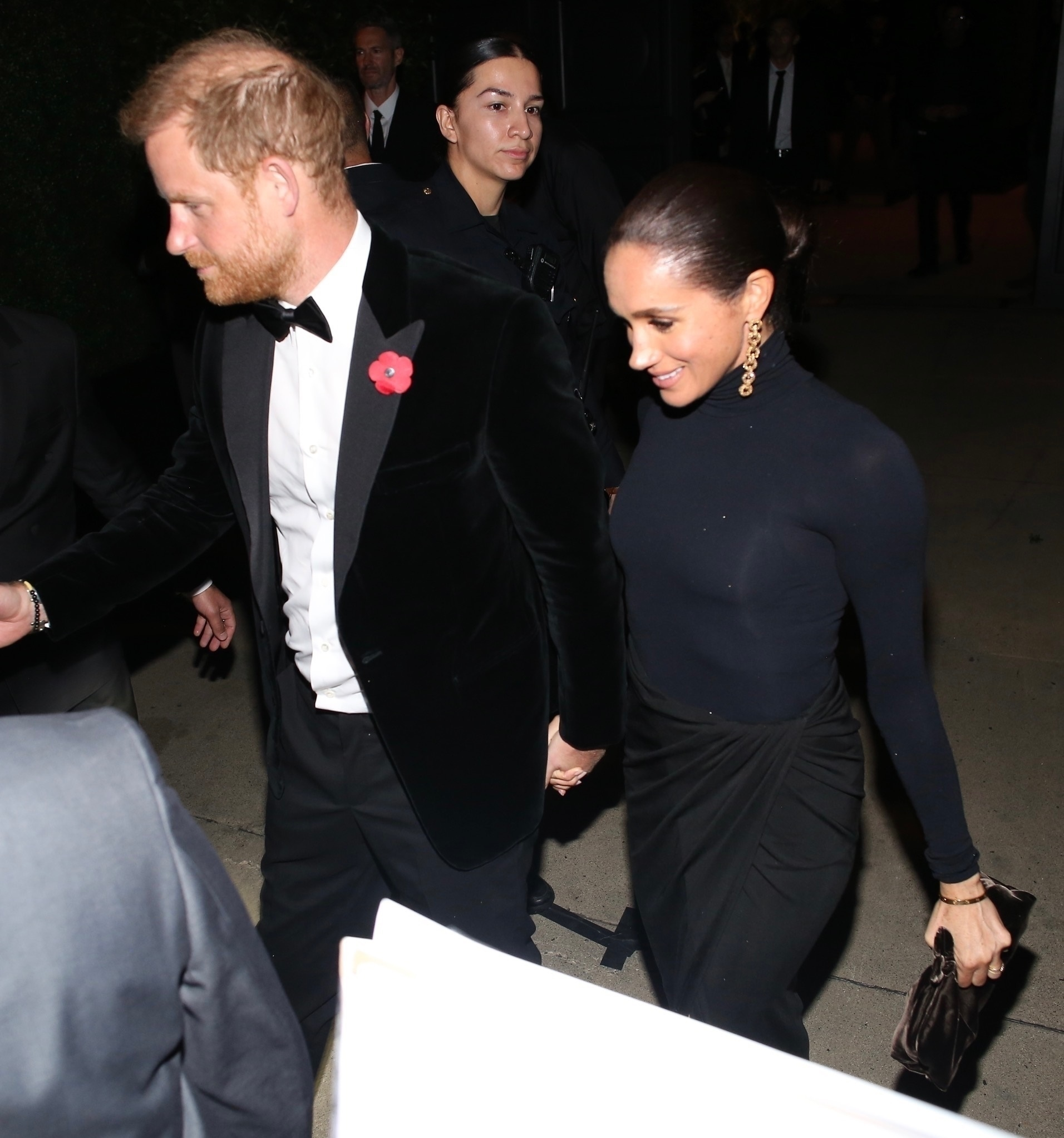 Prince Harry and Meghan Markle holding hands while leaving Kris Jenner's 70th birthday party.
