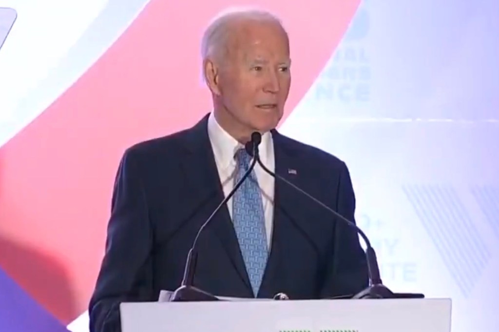 Joe Biden speaking at a podium with microphones in front of him.