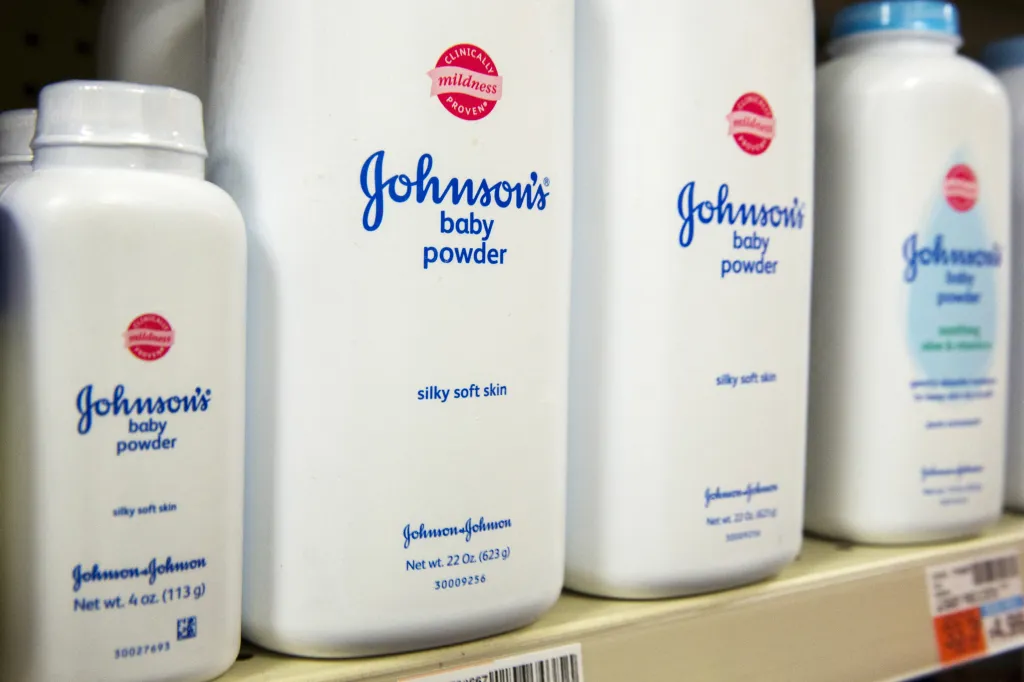 Bottles of Johnson & Johnson baby powder on a drugstore shelf.