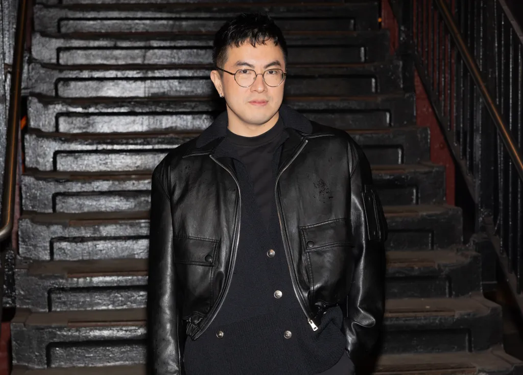 Bowen Yang attends the CHANEL 2025/26 Métiers d'art fashion show at Bowery subway station in New York.