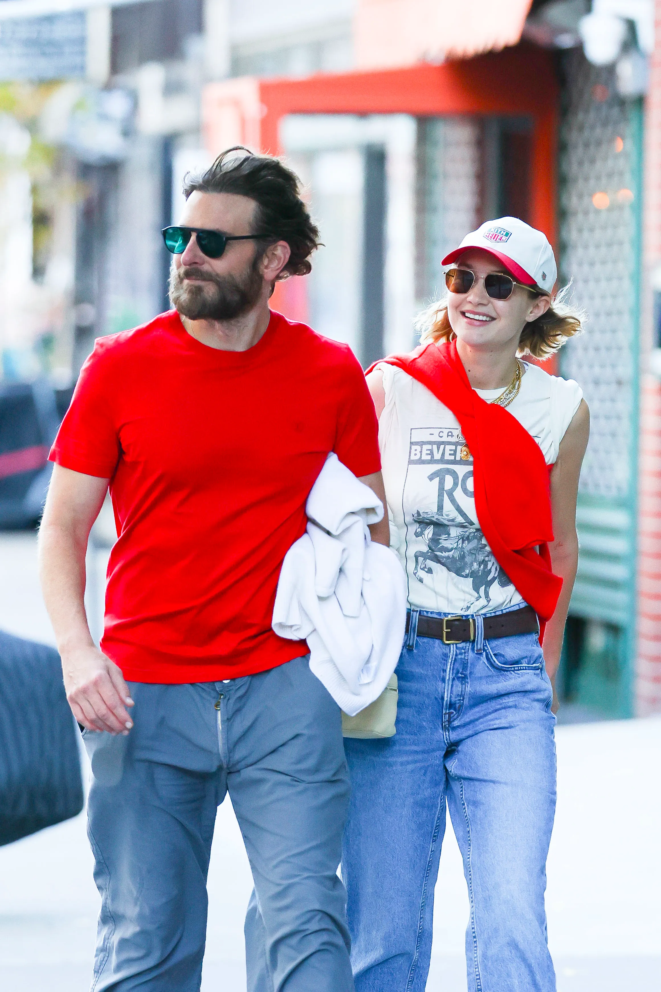 Bradley Cooper and Gigi Hadid walk down a city street.