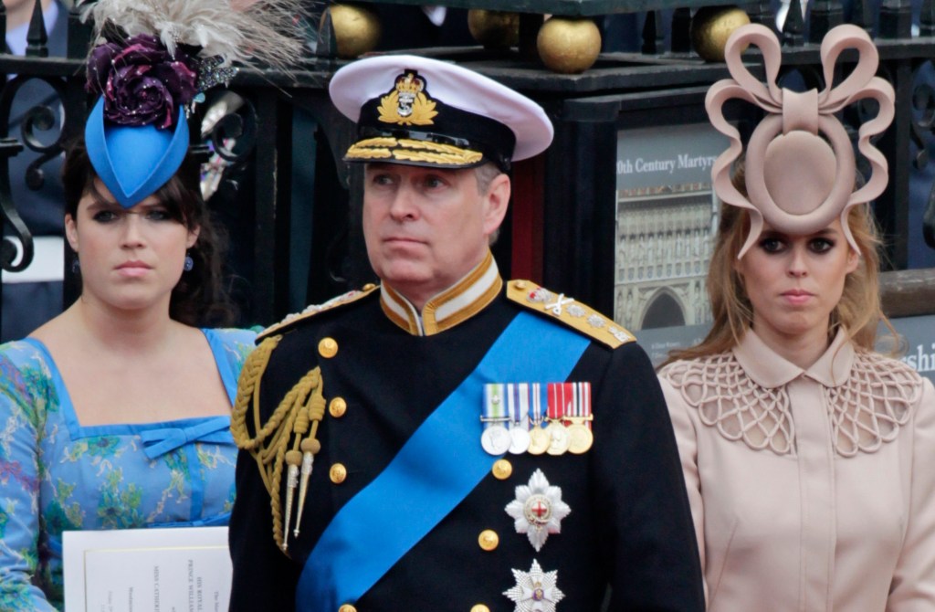 Britain's Prince Andrew, center, and his daughters Princess Eugenie, left, and Princess Beatrice leave Westminster Abbey.