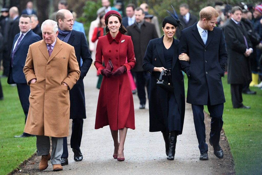 Prince Charles,in a brown coat and grey trousers, Prince William, in a black coat, black pants and a grey scarf, Catherine, Duchess of Cambridge, in a red coat and red hat. Meghan, Duchess of Sussex, in a black hat and black coat and black boots, and Prince Harry, in a black coat and black pants and a blue shirt and blue tie, attending Christmas Day service.