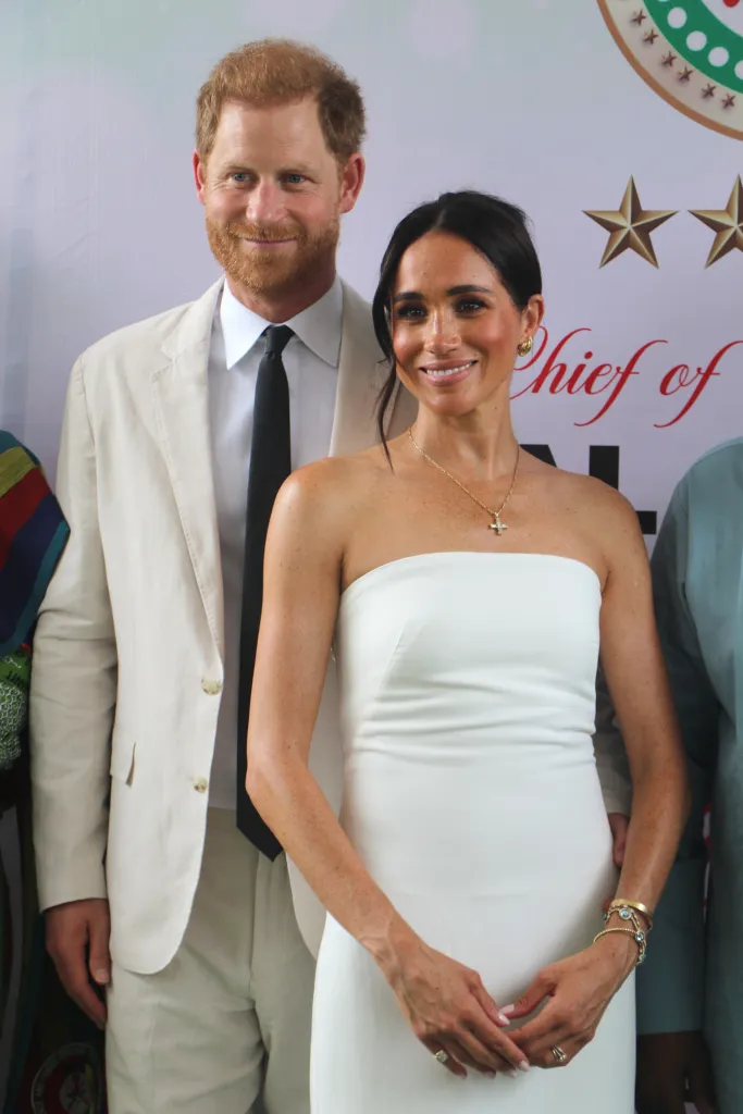 Prince Harry and Meghan Markle pose for a photo at an event during the Invictus Games Anniversary celebrations.