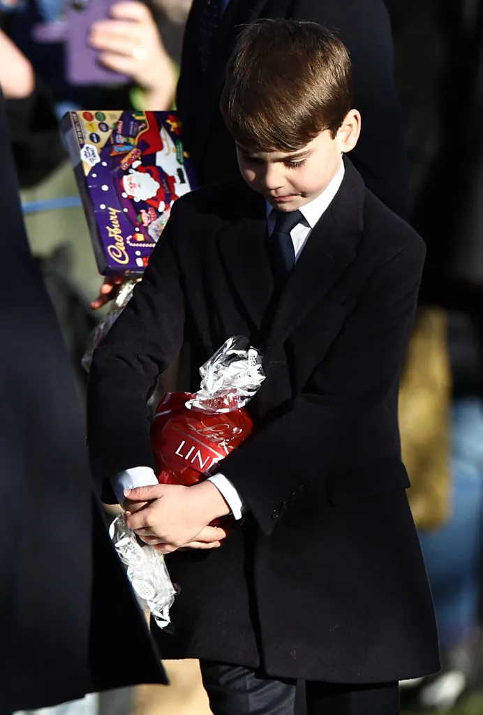 Prince Louis holding chocolate received from well-wishers on Christmas Day.