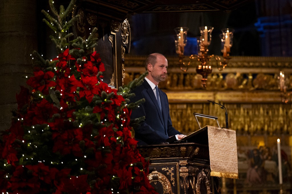Prince William speaking from a podium at a Christmas carol service.