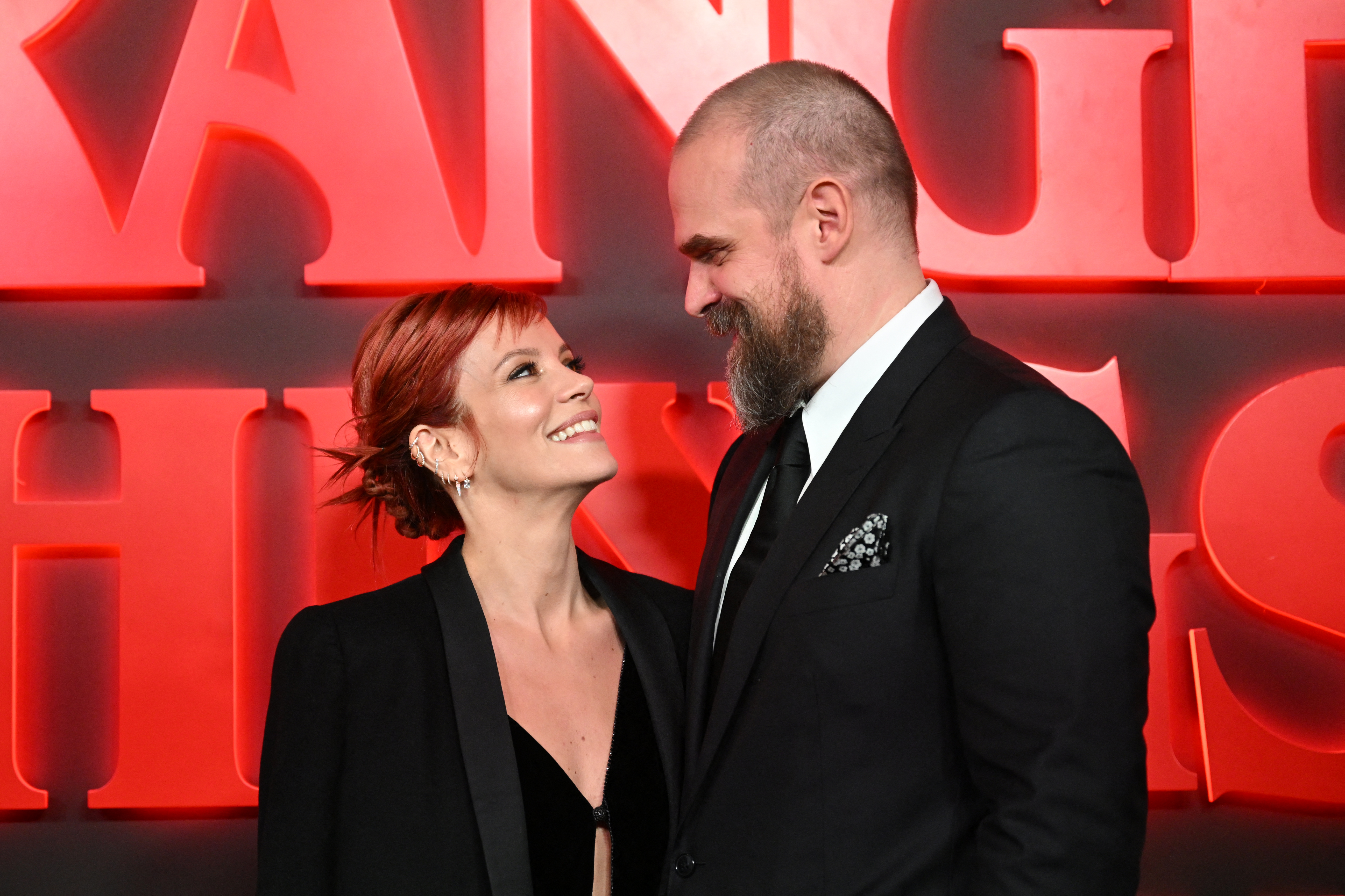 British singer Lily Allen and actor David Harbour posing on the red carpet at the West End world premiere of