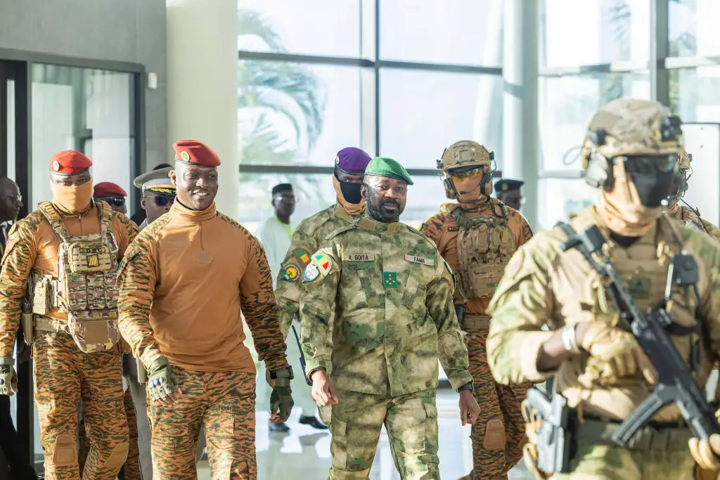 Burkina Faso's President Captain Ibrahim Traoré, second left, walks alongside Mali's President General Assimi Goïta during the Alliance of Sahel States (AES) second summit on security and development in Bamako, Mali, Tuesday, Dec. 23, 2025.