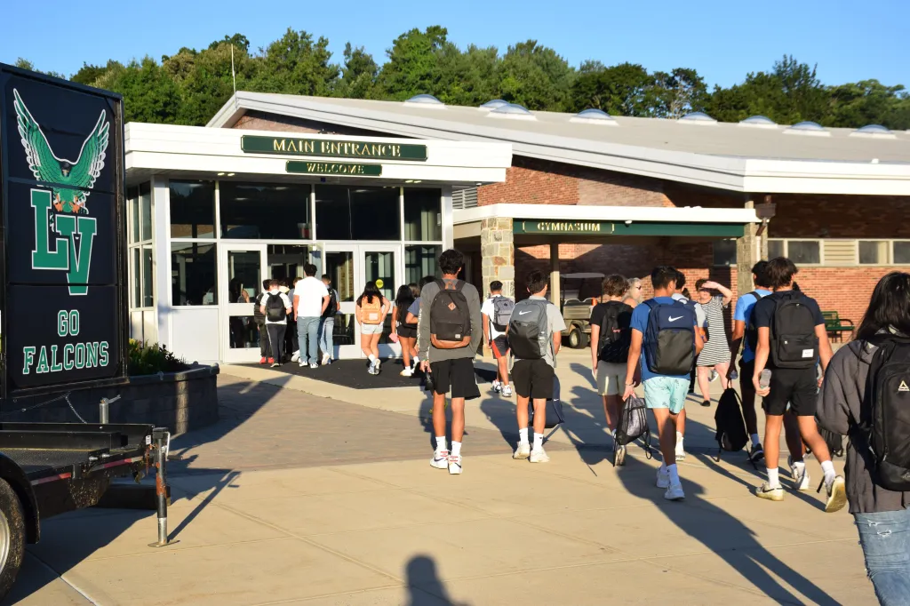 Students walking into the main entrance of Locust Valley School District, with the 