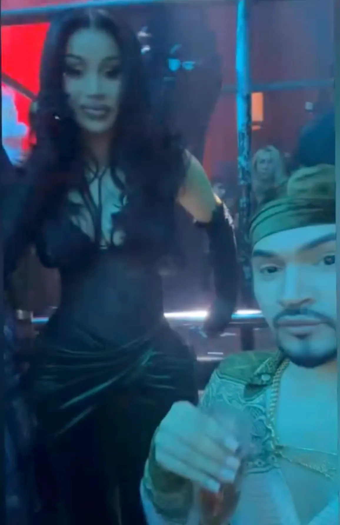 Cardi B and her friend Ken Barbie in a dimly lit setting.