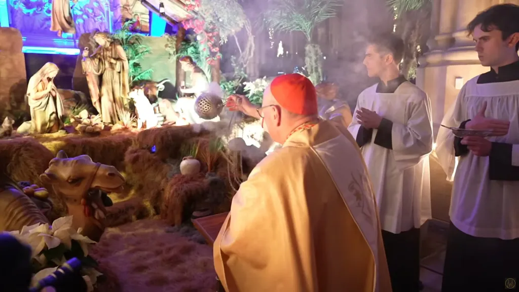 Cardinal Timothy Dolan holding a censer during midnight mass at St. Patrick's Cathedral.