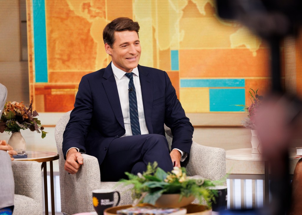 CBS Mornings Co-Host Tony Dokoupil smiling and seated in a chair.
