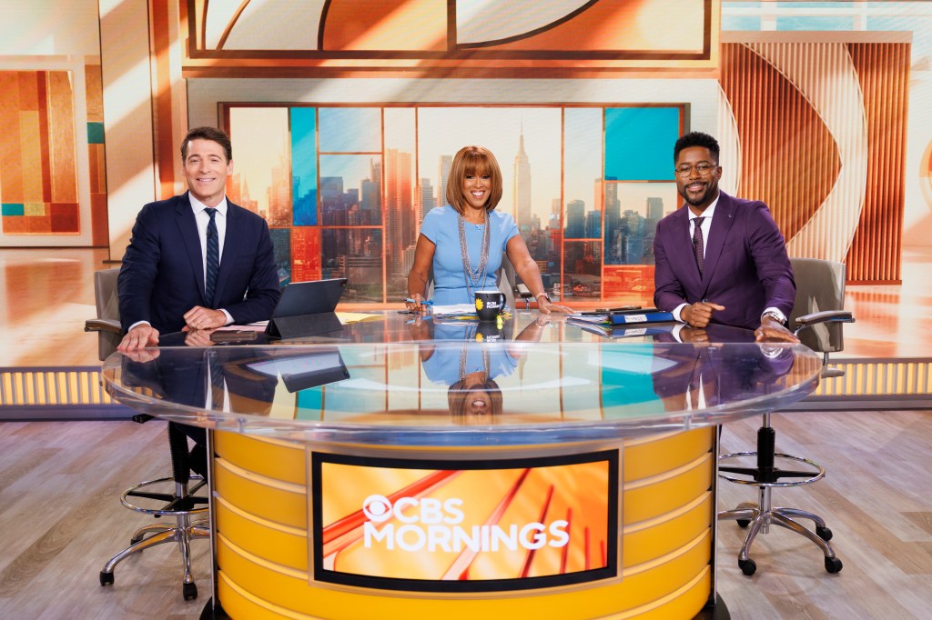 CBS Mornings co-hosts Gayle King, Tony Dokoupil, and Nate Burleson seated at the broadcast desk.