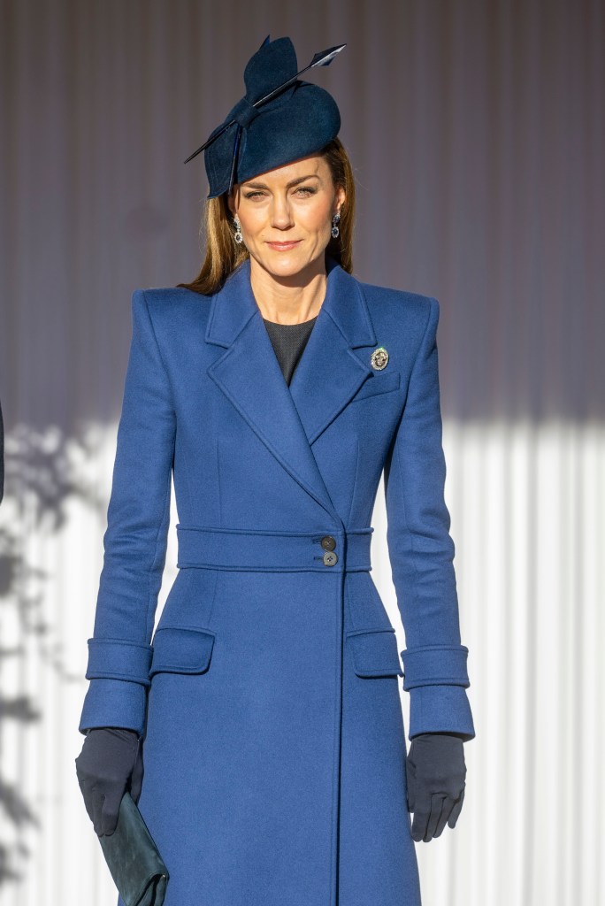 Catherine, Princess of Wales, in a blue coat, hat, and brooch.