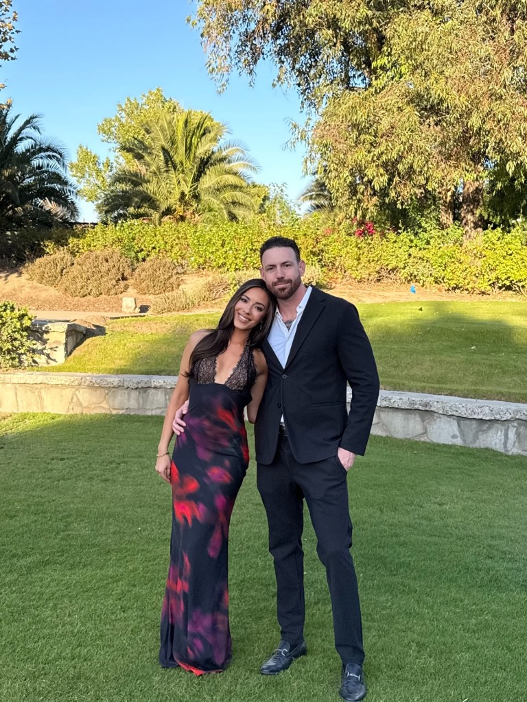 Charli Burnett and Corey Loftus embracing outdoors.