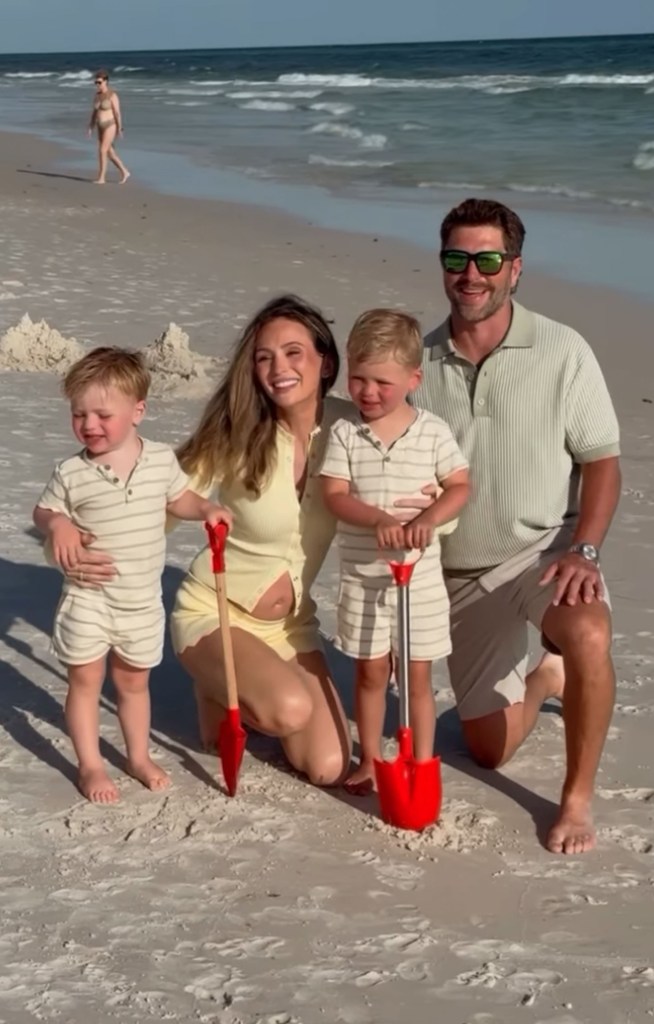 Lauren and Chris Lane with their two sons Dutton and Baker on the beach.