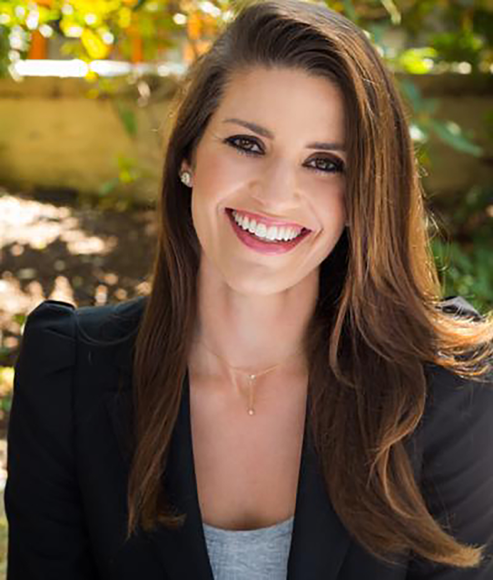 Meredith Kendall, ex-publicist for Meghan and Harry, smiles.