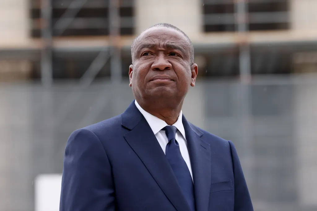 Cleo Fields in a dark suit and tie attends an event at the Supreme Court.