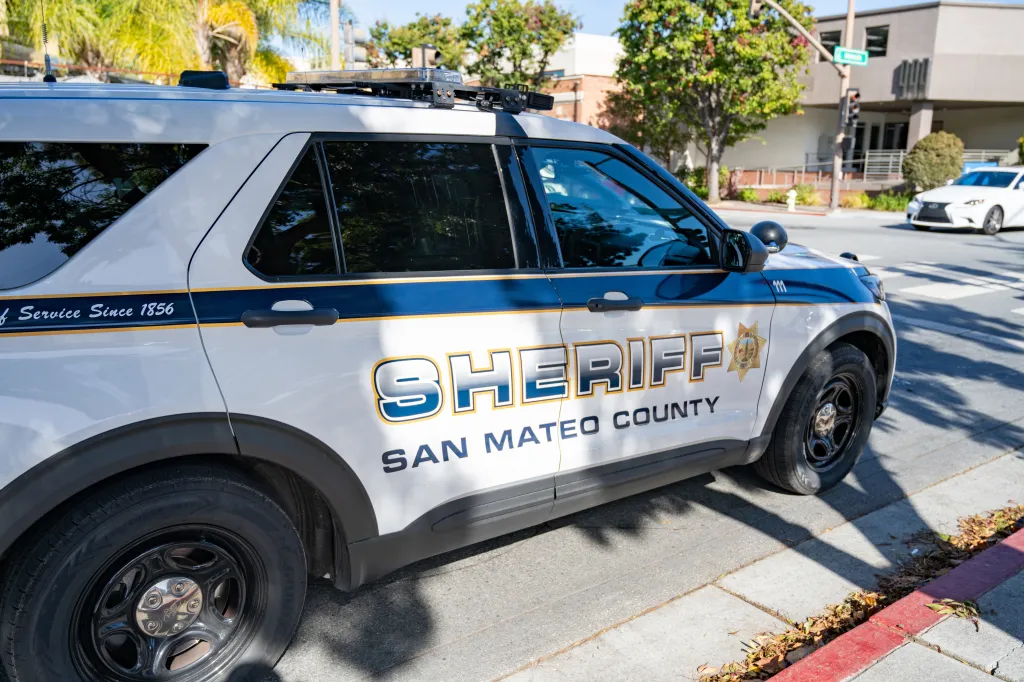 Side view of a white San Mateo County Sheriff patrol vehicle with 