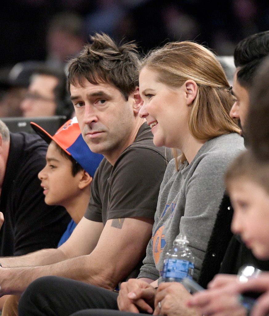 Amy Schumer and Chris Fischer courtside at a New York Knicks game.