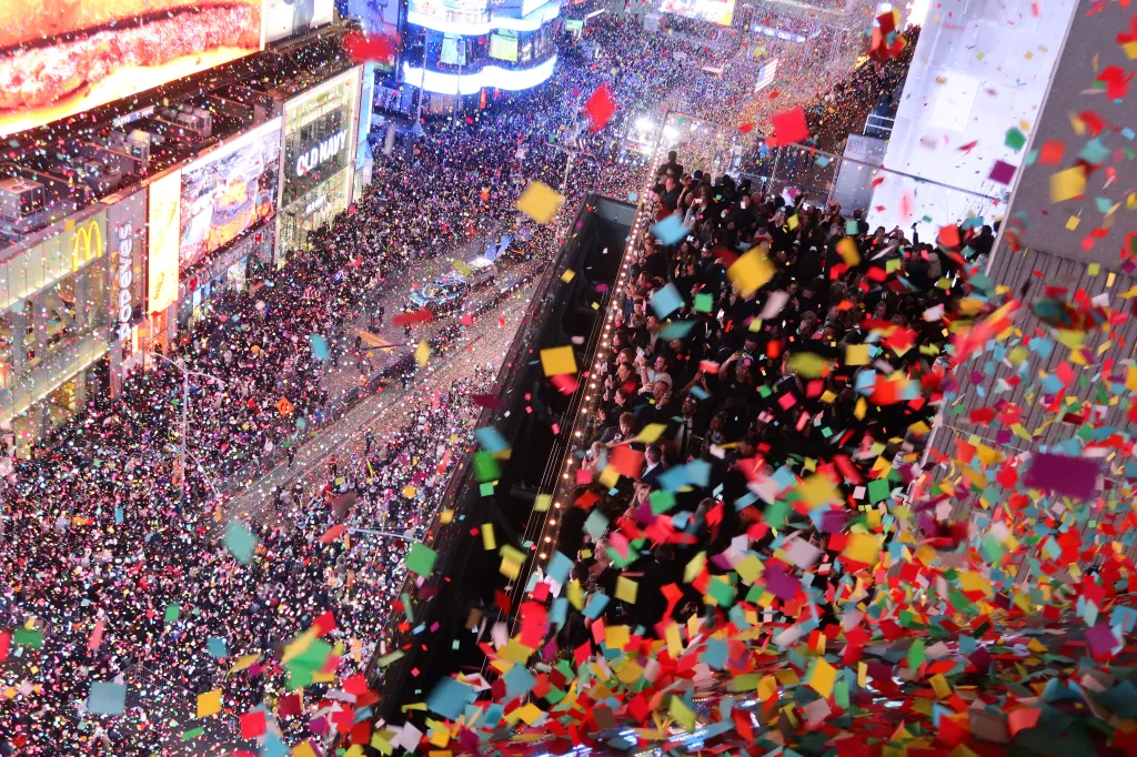 Confetti falling on revelers in Times Square during New Year's festivities.