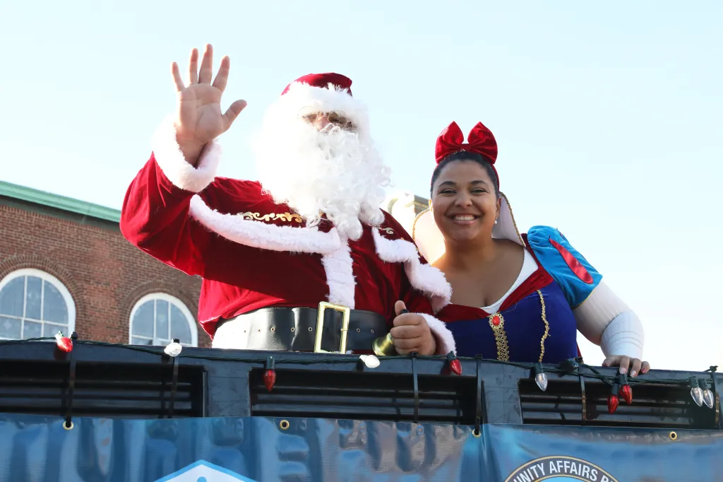 Santa Claus and a woman dressed as Snow White on a float.