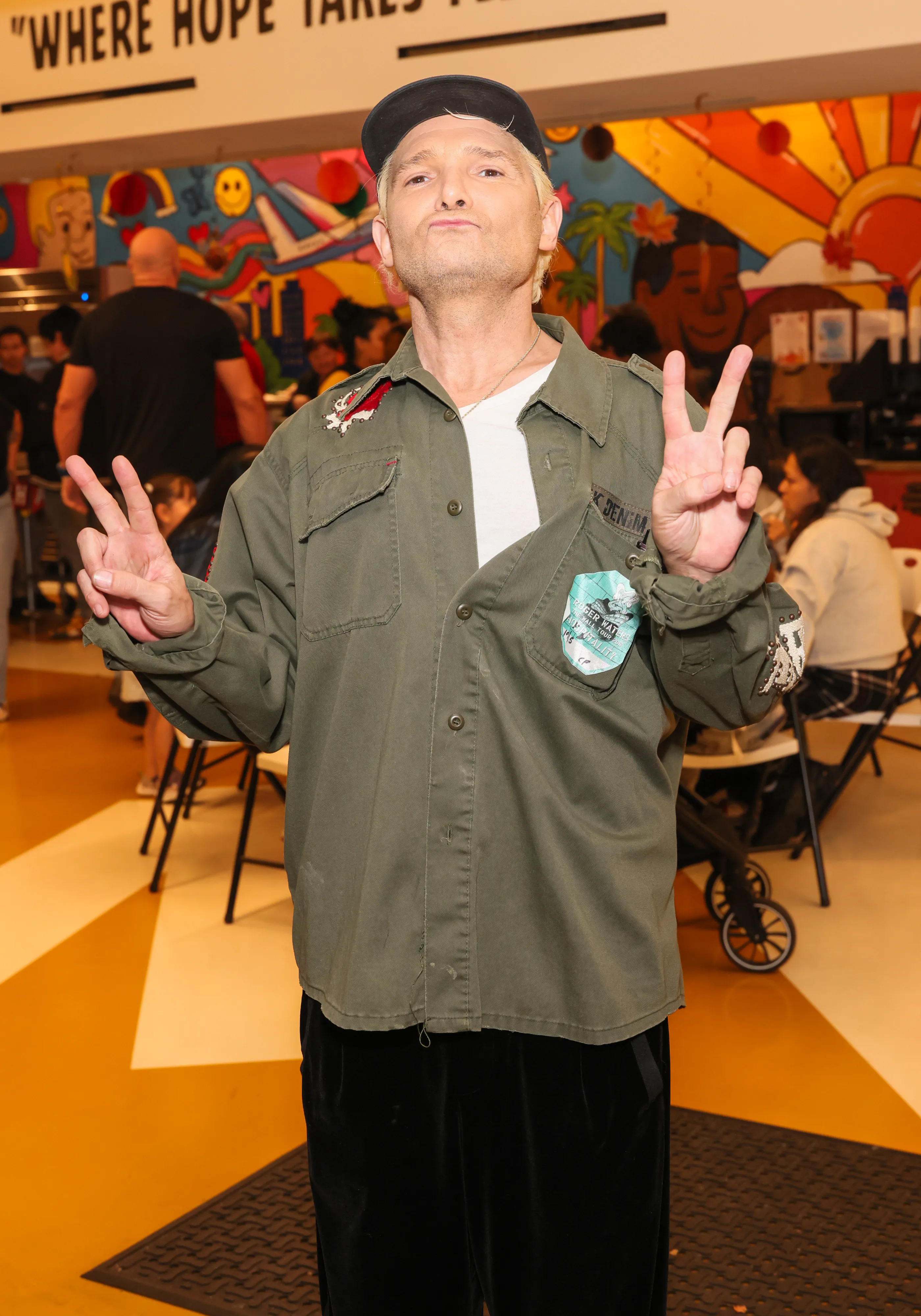 Corey Feldman making peace signs at Hope The Mission and Los Angeles Mission Thanksgiving dinner.
