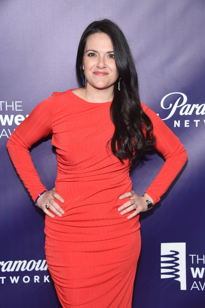 Nomiki Konst in a red dress.