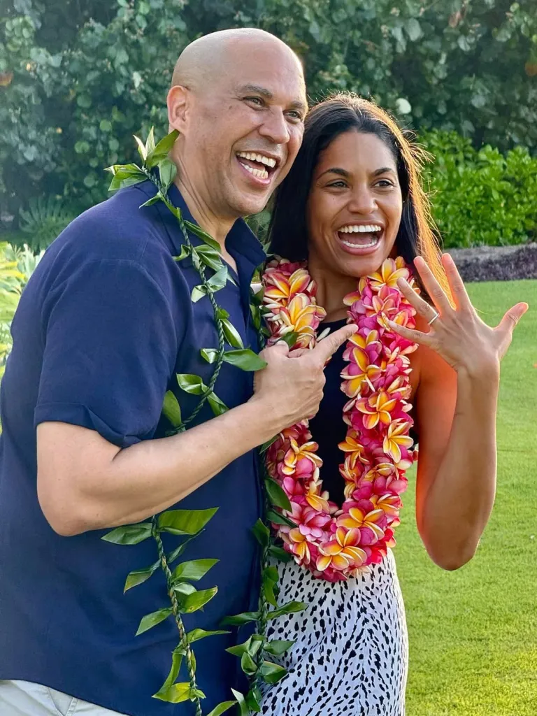 Cory Booker points to Alexis Lewis's engagement ring.
