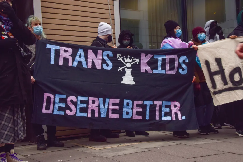 Protesters hold a banner that reads 
