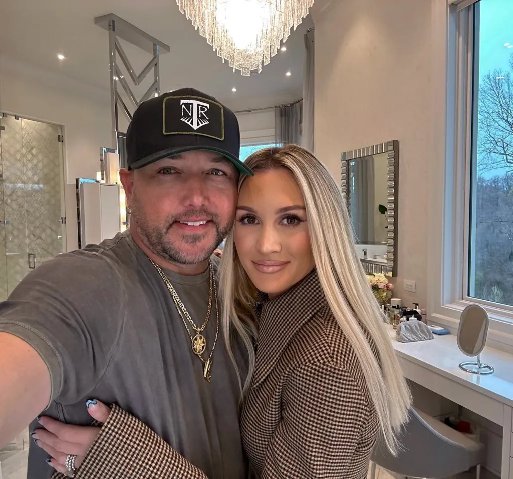 Jason Aldean and Brittany Aldean posing for a photo.