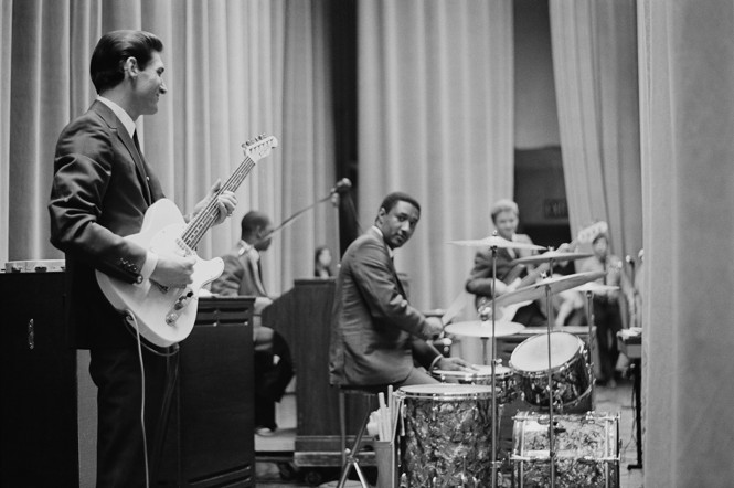 A black and white photo of Booker T and the MG's playing together at Hunter College