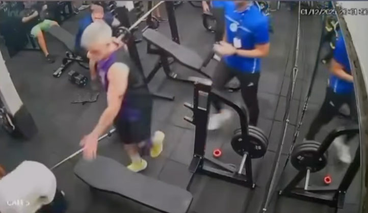 CCTV footage of a man at a gym dropping a barbell on his chest.