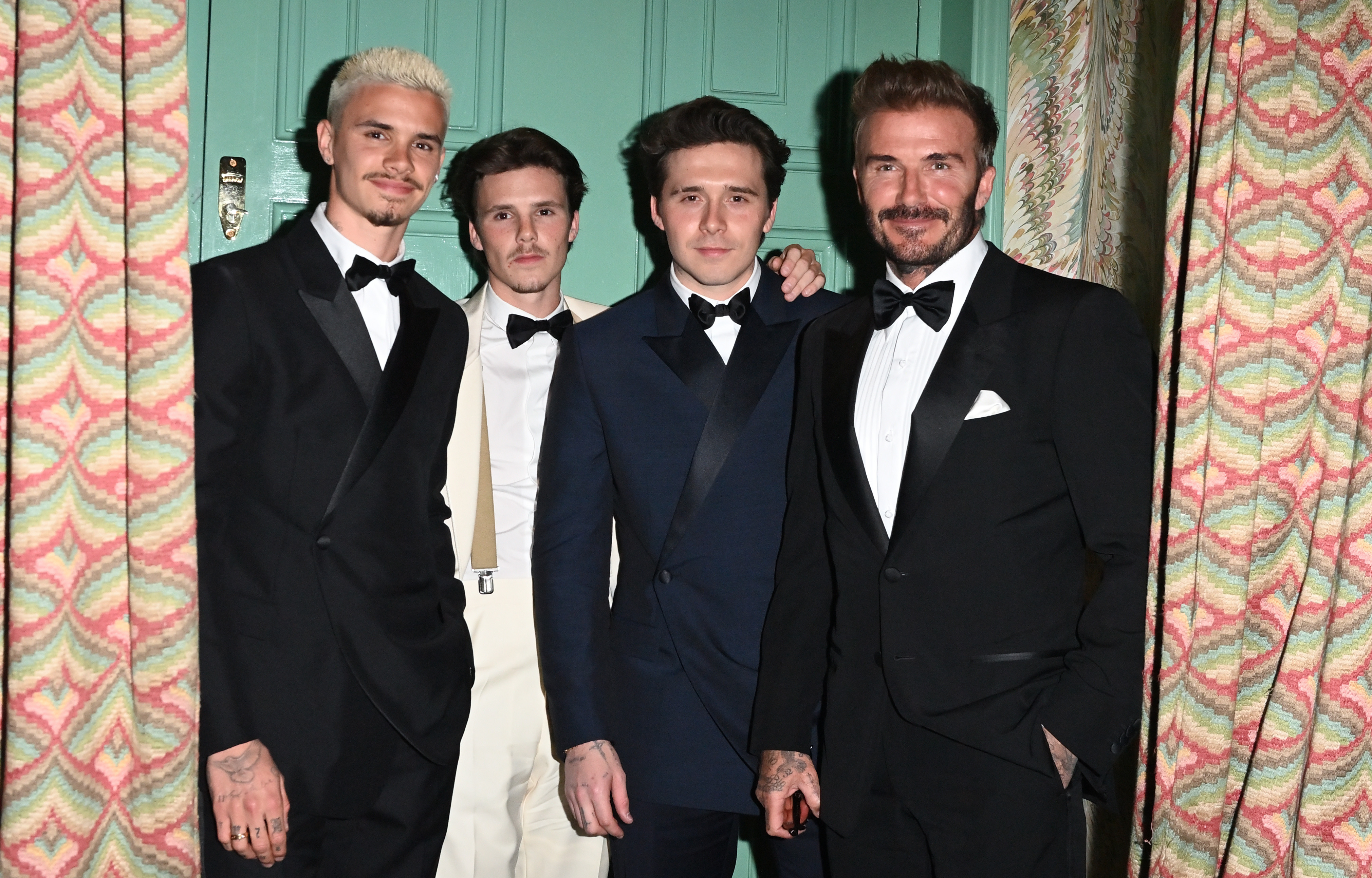 David Beckham, Brooklyn Beckham, Romeo Beckham, and Cruz Beckham in formal attire at Victoria Beckham's 50th Birthday Party.